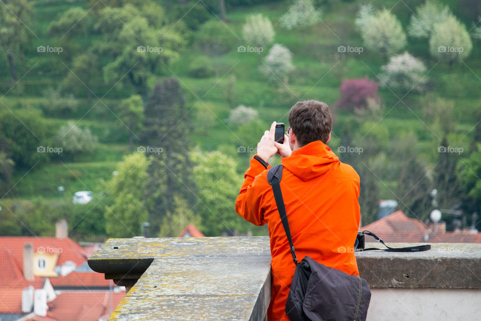 Tourist taking a photo on his phone