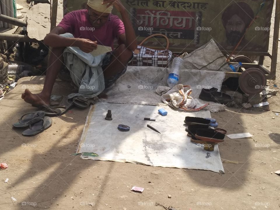 poor man shoe police bussiness in very hot environment, looking face in broken mirror with broken goggles