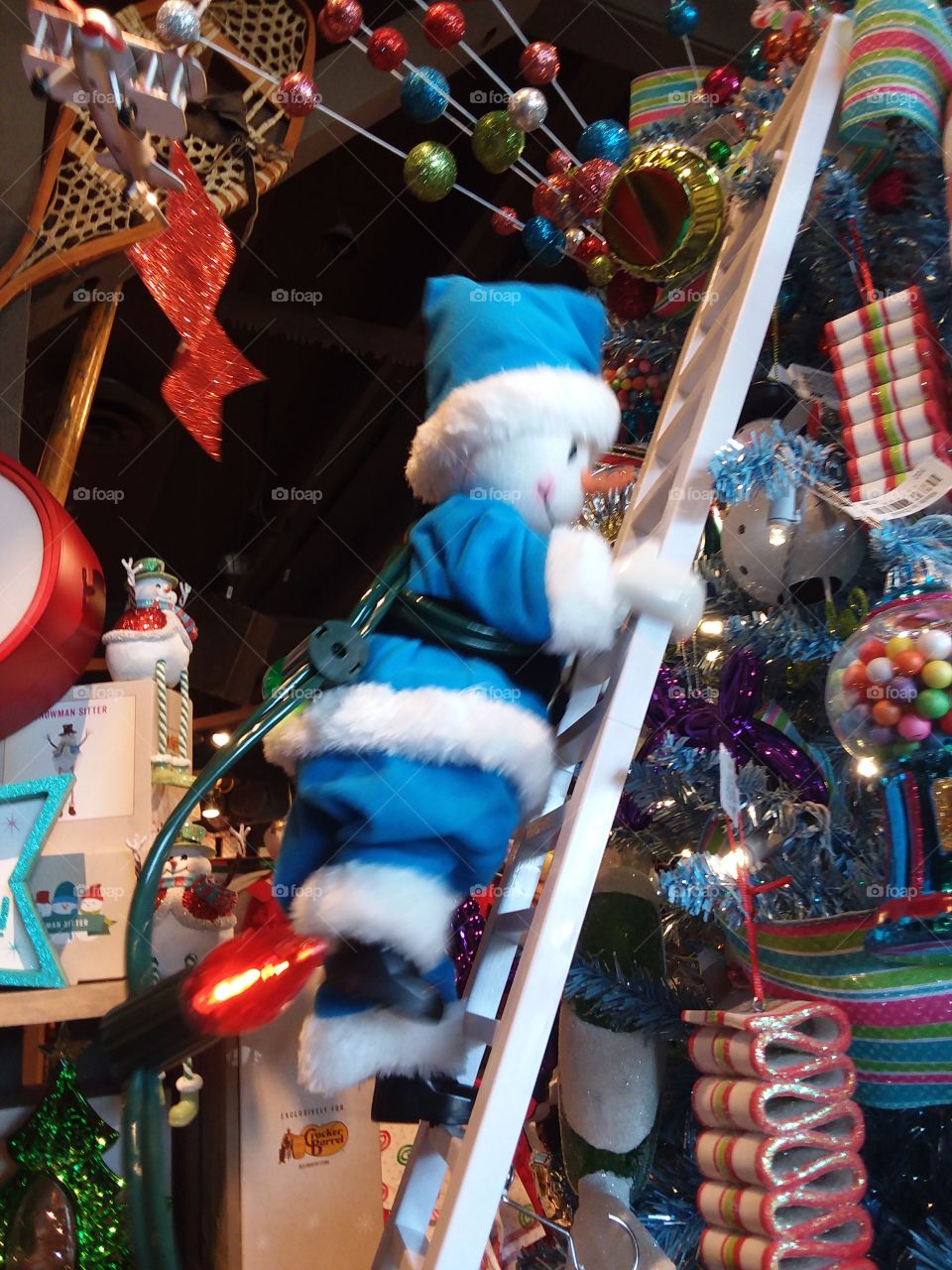 santas helper climbing ladder to hang lights on the tree using the ladder to get from point A to point B