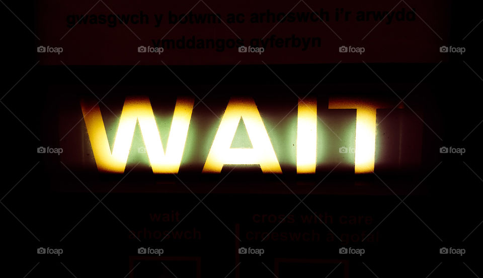 Glowing yellow Wait letters