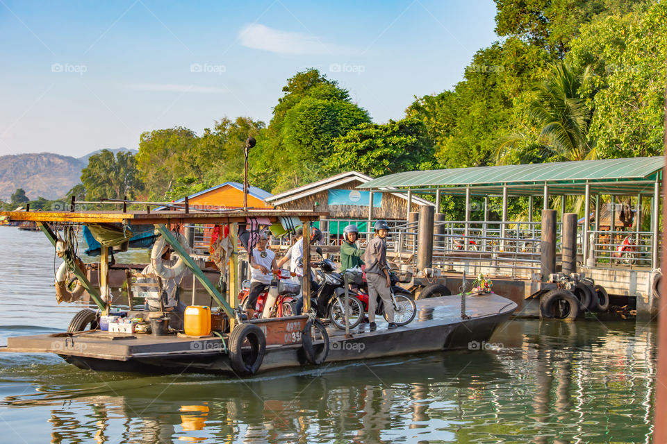 Ship passenger and motorbikes across  Khwae Noi river at Kanchanaburi Thailand.