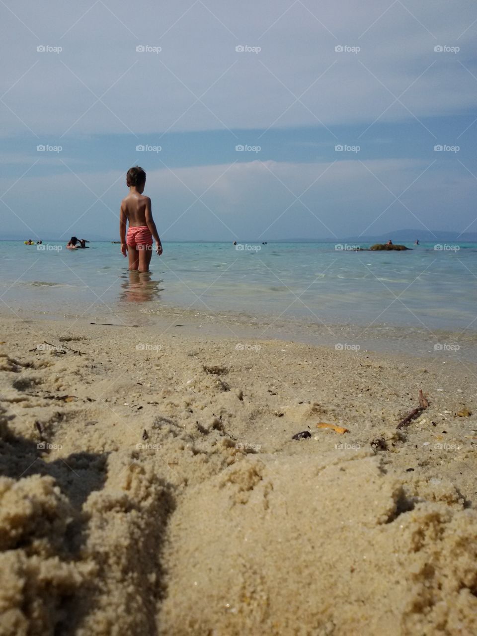 Small boy with showel on beach