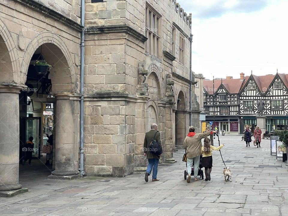 A family walking through town on a school run home 