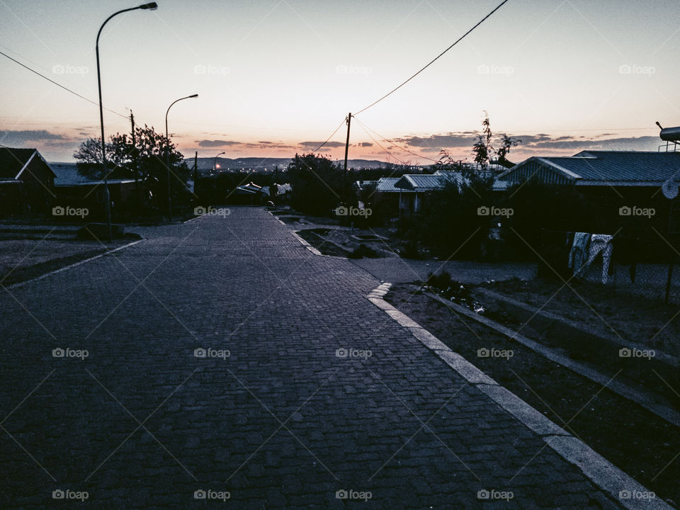 Evening view of a beautifully paved downsloping street.