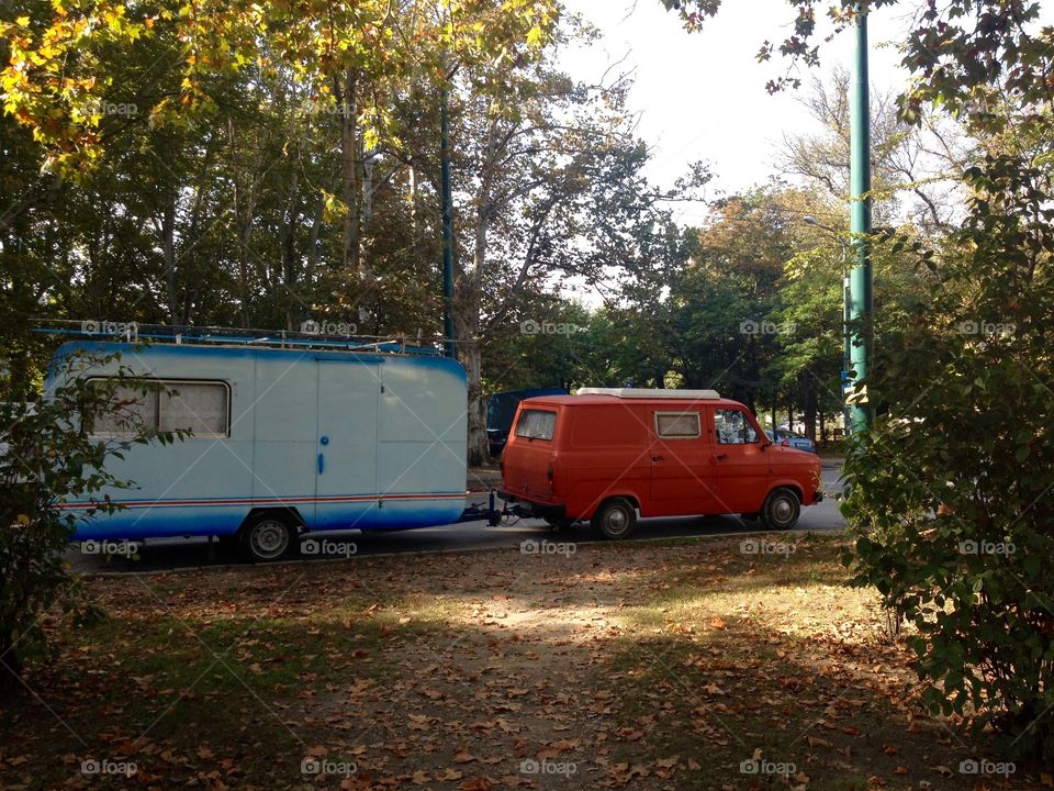 Old car with mobile home in the streets of Autumn