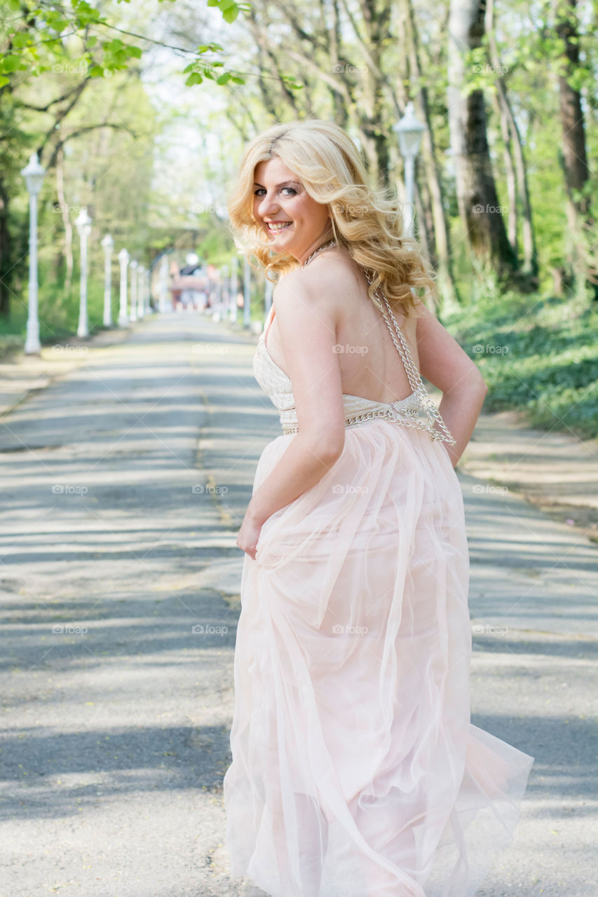 beautiful woman running. beautiful woman in evenong gown.running in the woods