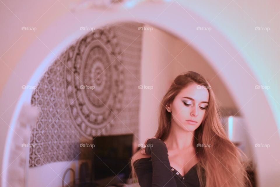 Reflection in the mirror, beautiful young woman, contemplative expression, candid moment