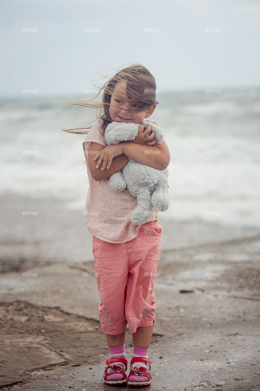 Girl portrait near sea a windy day