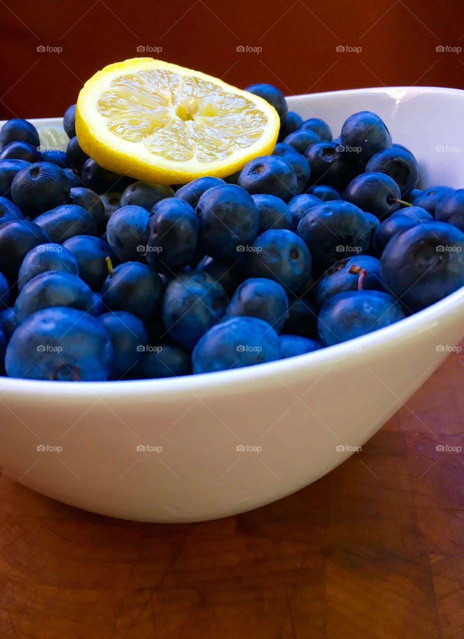 Blue berries in bowl with lime slice