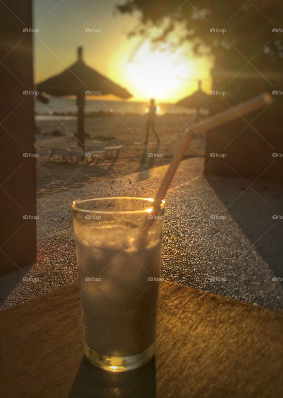 A drink by the beach at sunset