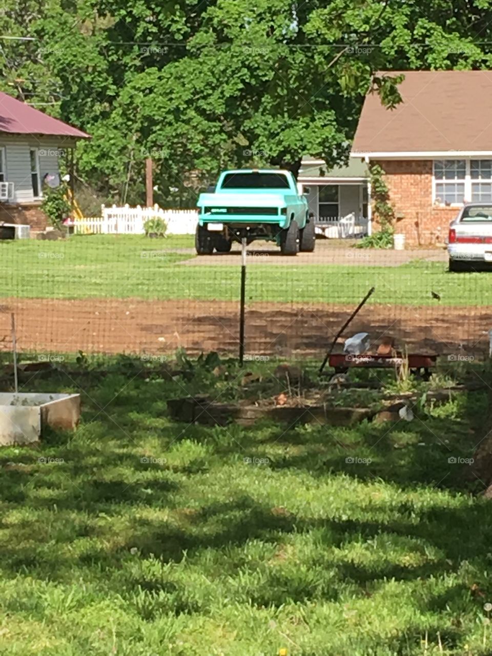 Sweet GMC custom made turquoise green and black  pickup truck. 70’s model with lift.