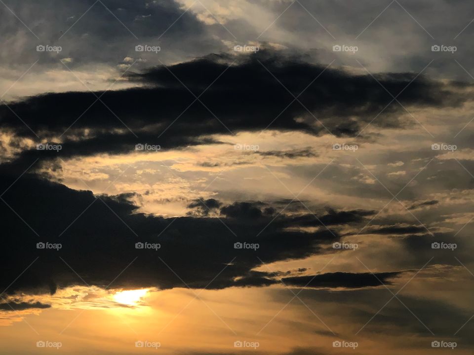 The sun, behind some clouds... 