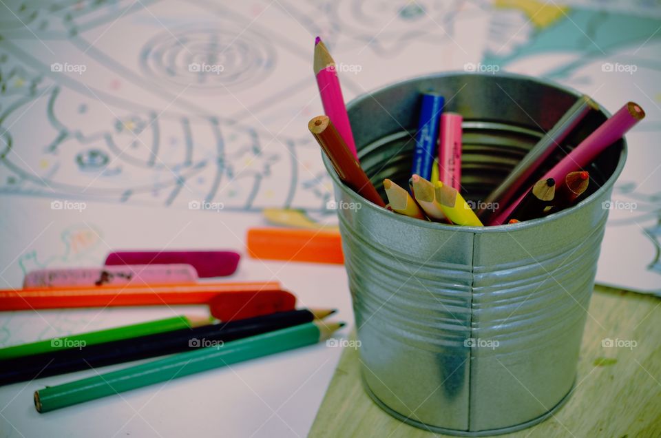 Color pencils in holder and drawing papers