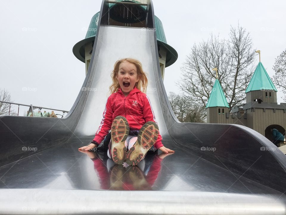 A little girl sliding at lighthouse