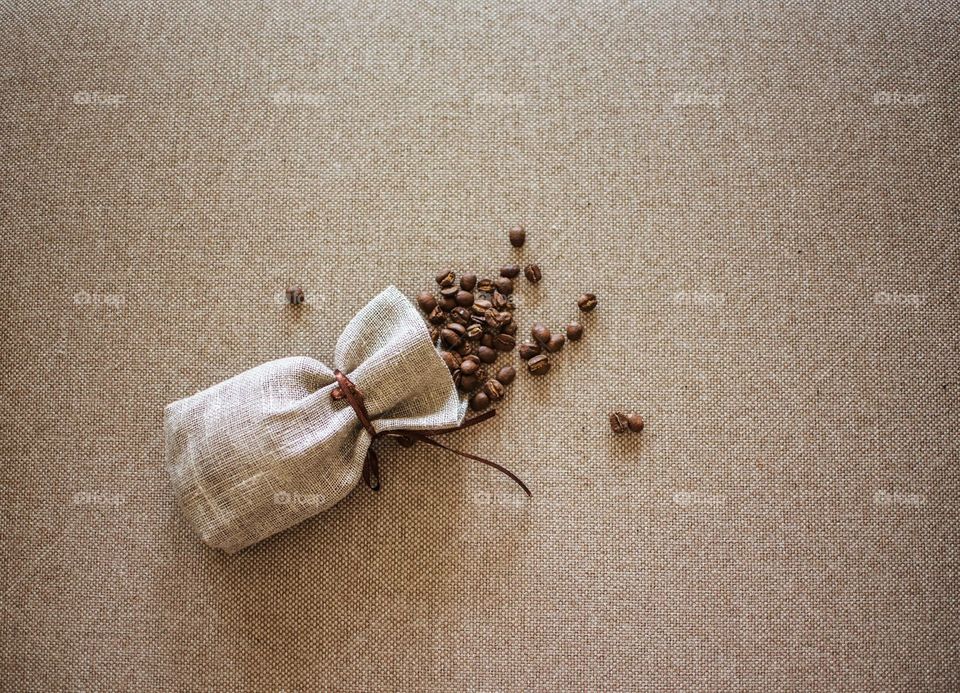A Coffee Sack With Scattered Coffee Beans 