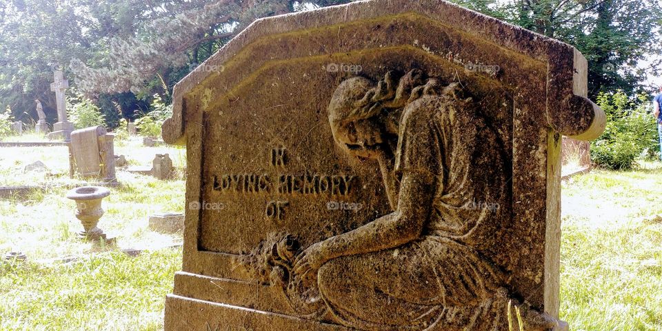 carved gravestone in graveyard