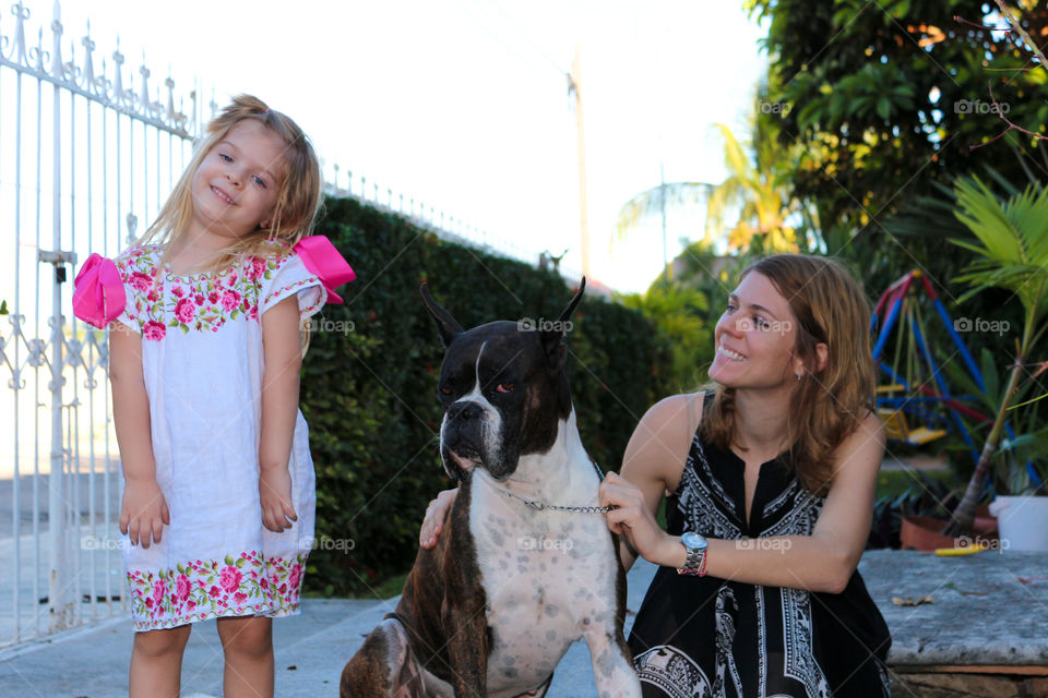 Mother and daughter with their pet dog