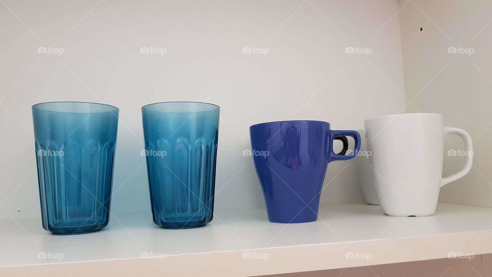 Mugs and drinking cups stored in cupboard