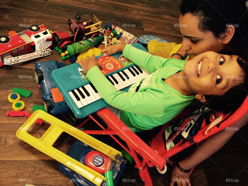 Playful time indoor . Playing piano 