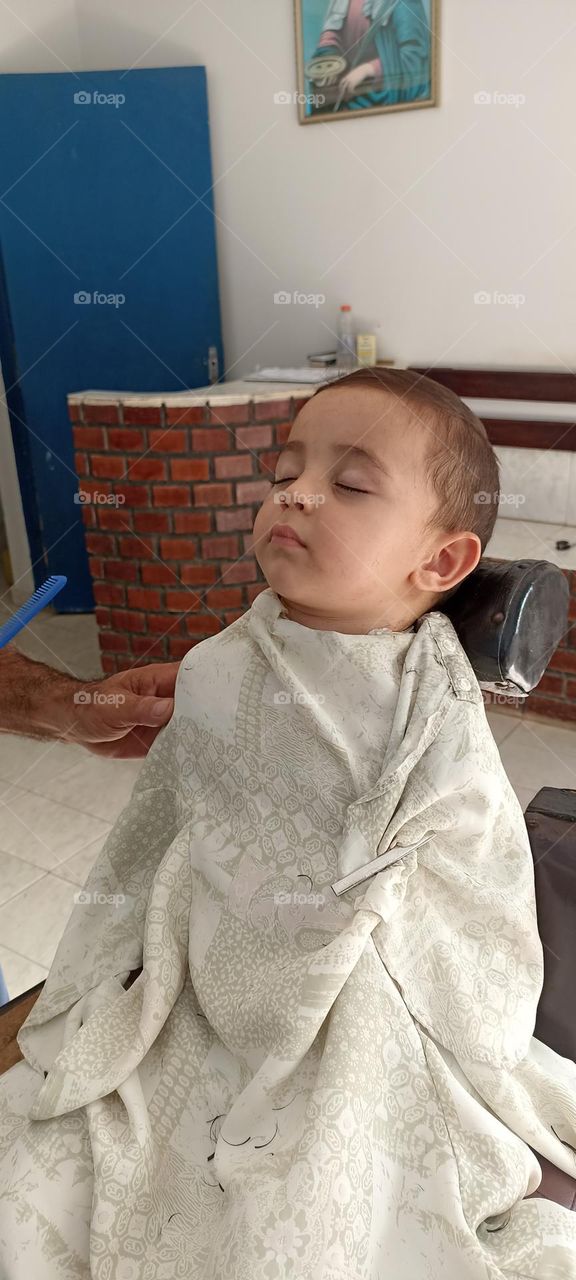 Boy falls asleep while cutting his hair