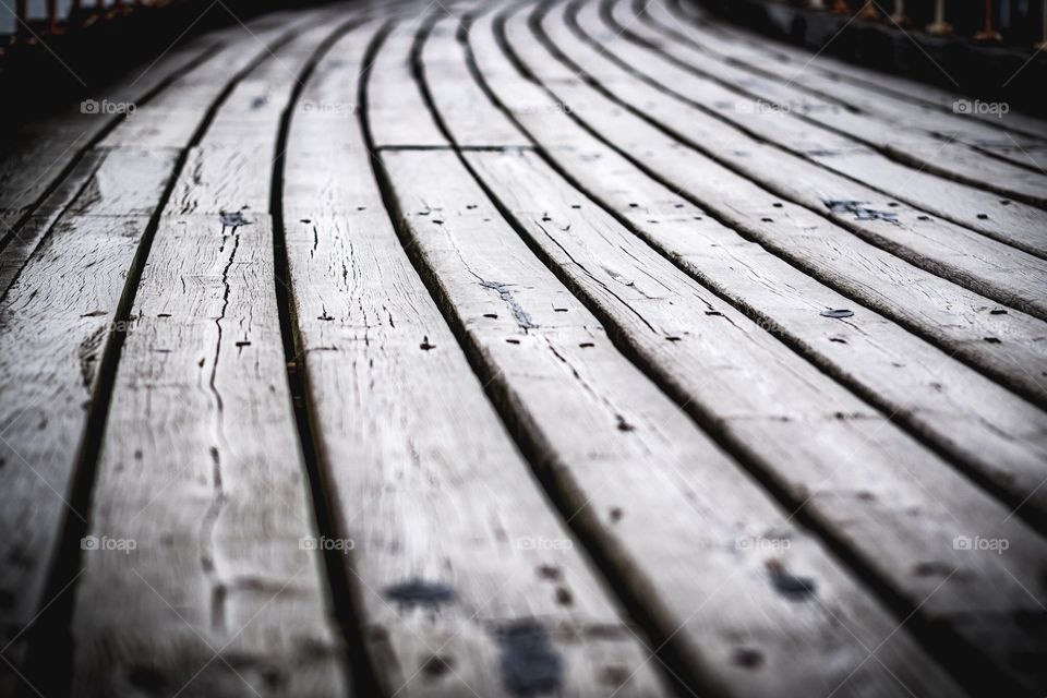 Bend in the Boardwalk . Close-up image of a bend in a wooden boardwalk, or pier, with no people and lots of text space. 