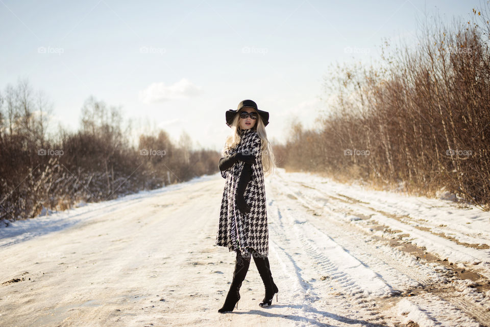 Fashionable woman on road during winter