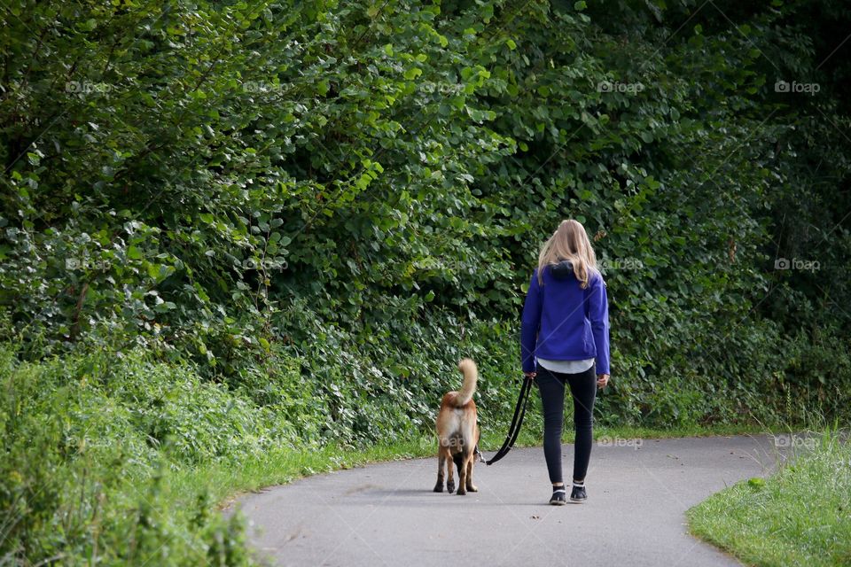 Girl Walking With Her Dog 