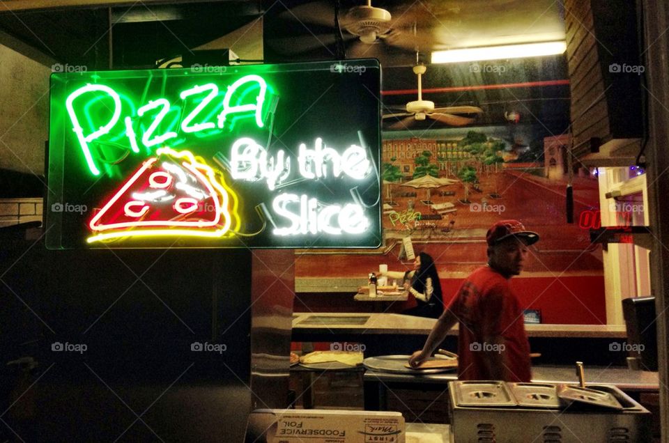 Pizza restaurant with neon sign at night