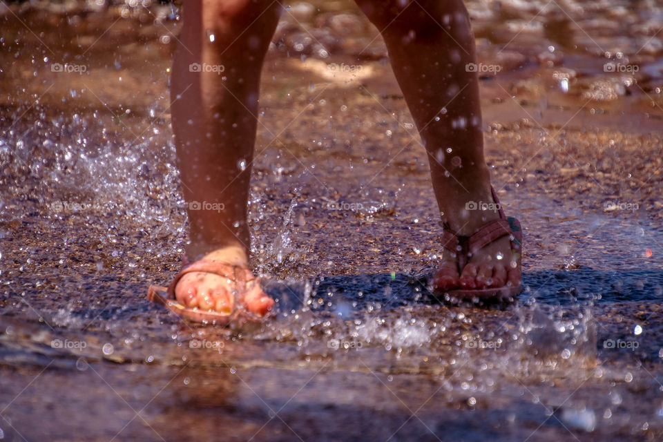 Cute little feet in a splash pad