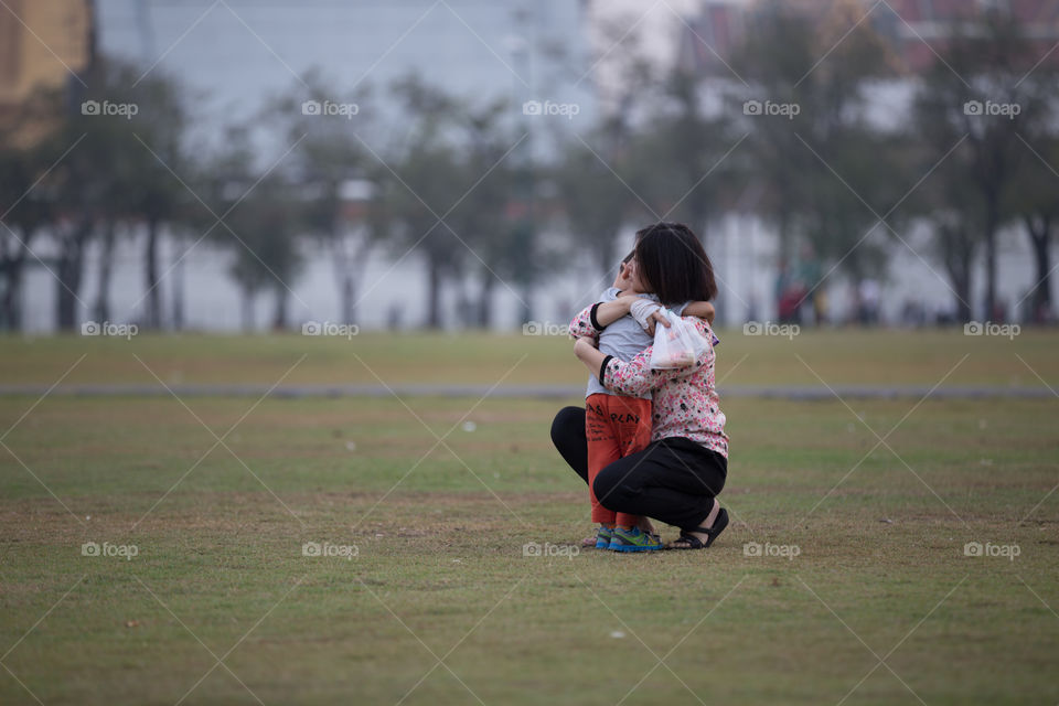 Mother holding her child in the park