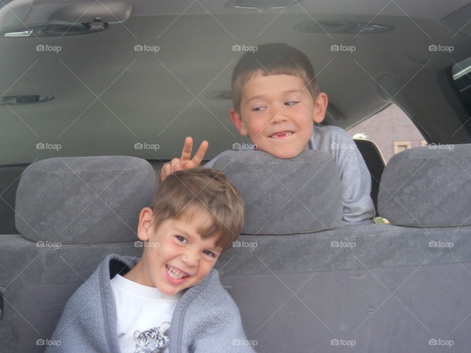 Two boys sitting in car