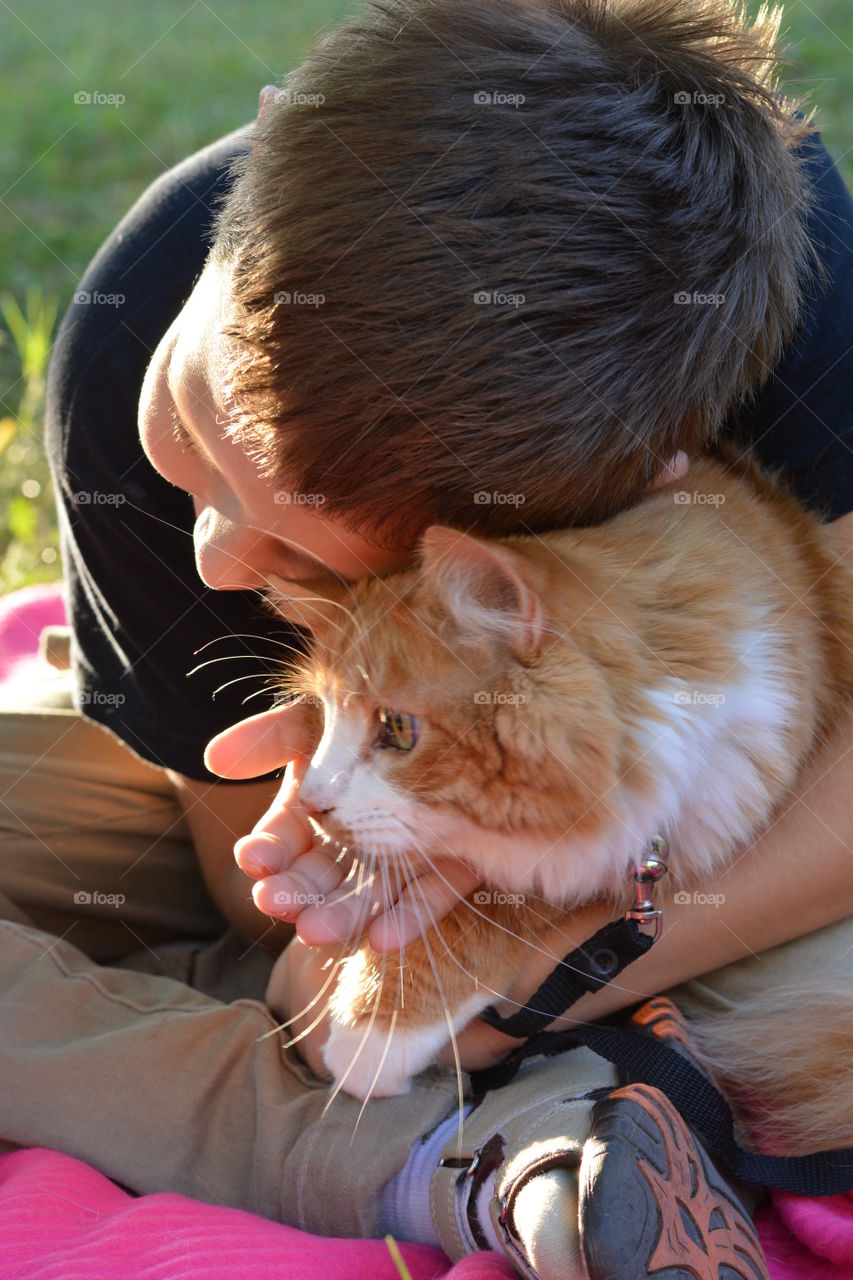 child with ginger cat outdoor family, love pet