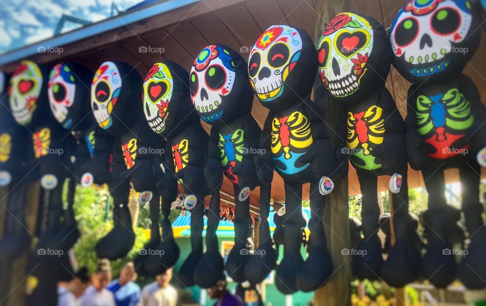 Colorful Day of the Dead Dolls Hanging from a vendor’s stalk for sale to tourists