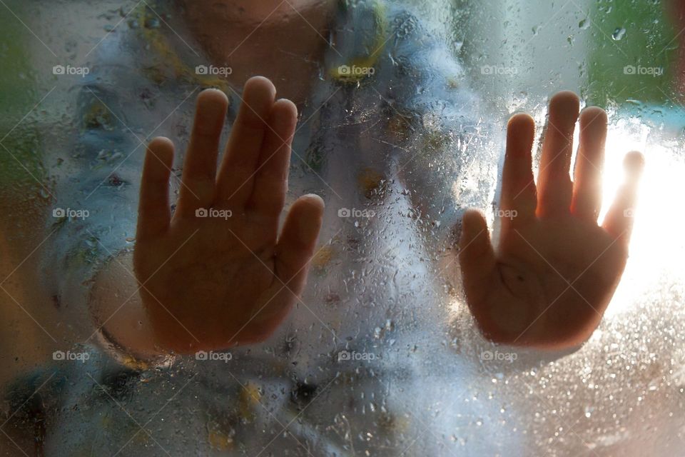 baby hands on wet glass