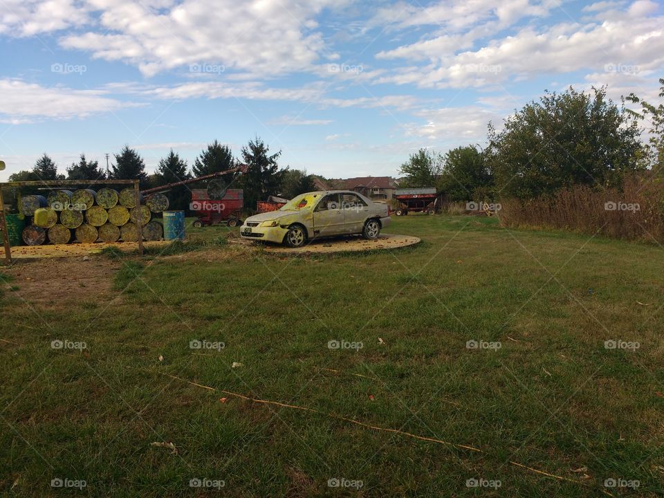 car used as target for paintball shootout and corn cannon.