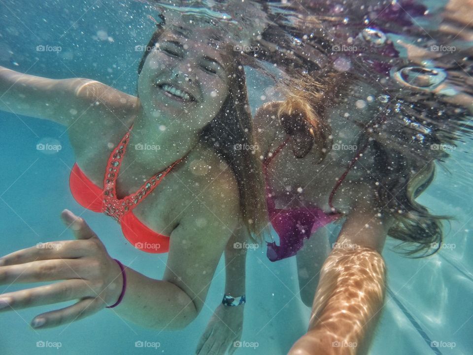 Female friends swimming underwater