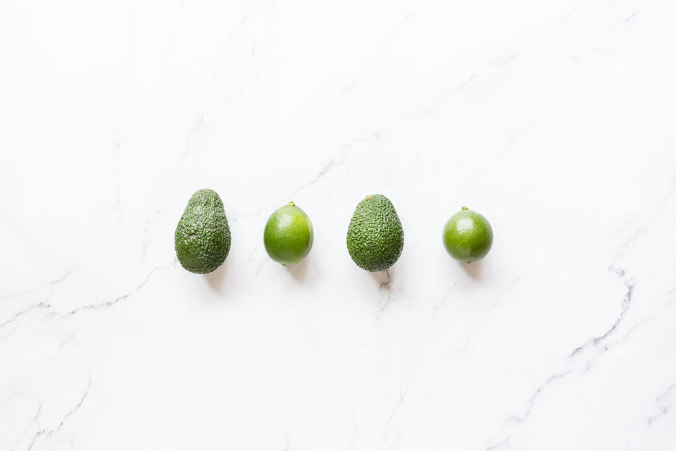 Fresh fruits green color on white marble background 