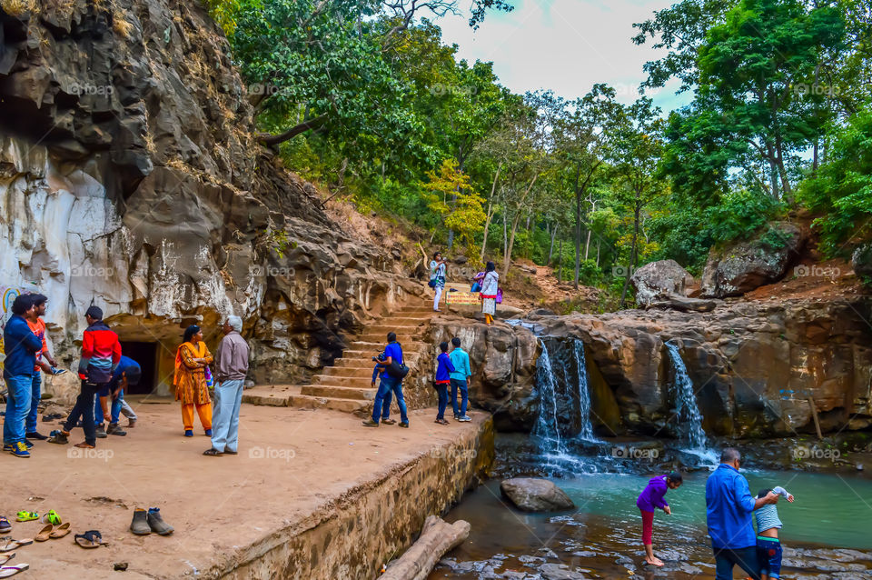 AMARKANTAK, INDIA MAY-6 2017: Tourist come See the sacred "Kapil DHARA" in "KAPIL MUNI ASRAM" of Himalayan region where Narmada river flows in the form of waterfall, surrounded by dense forest hills.