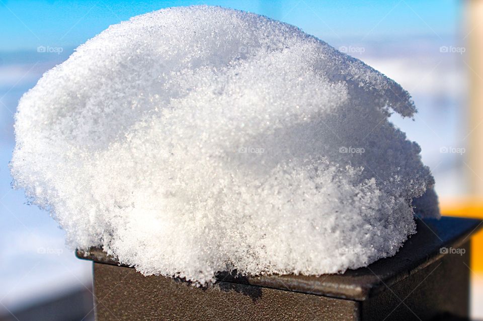 Snowfall pile up on back deck rail 