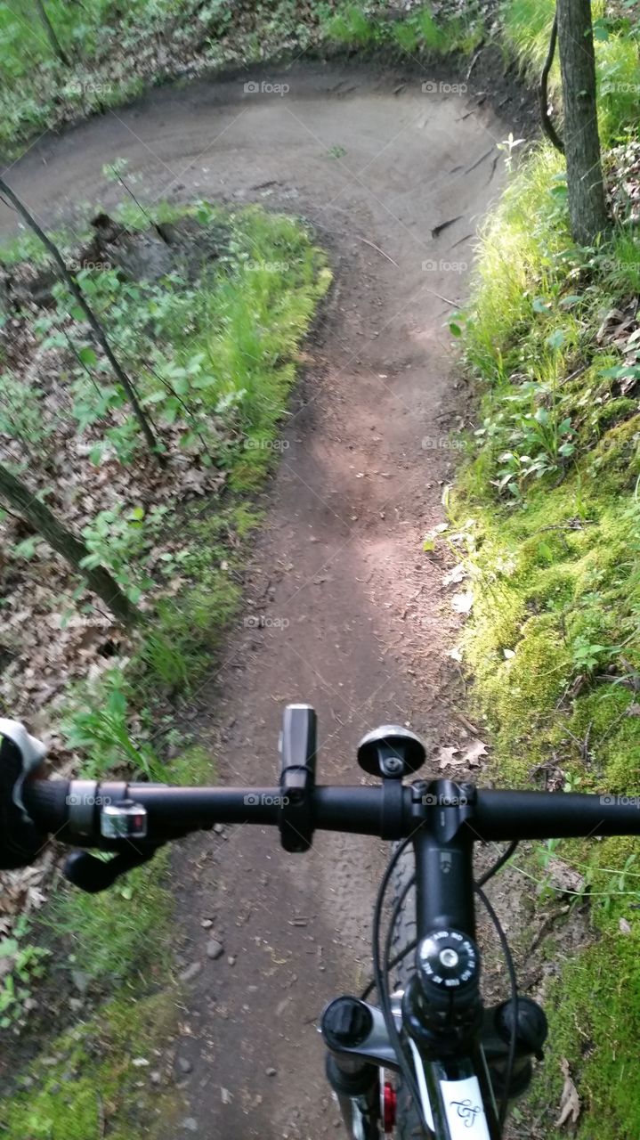 Looking past my handle bars at the turn a head of me on the trail from a different view.