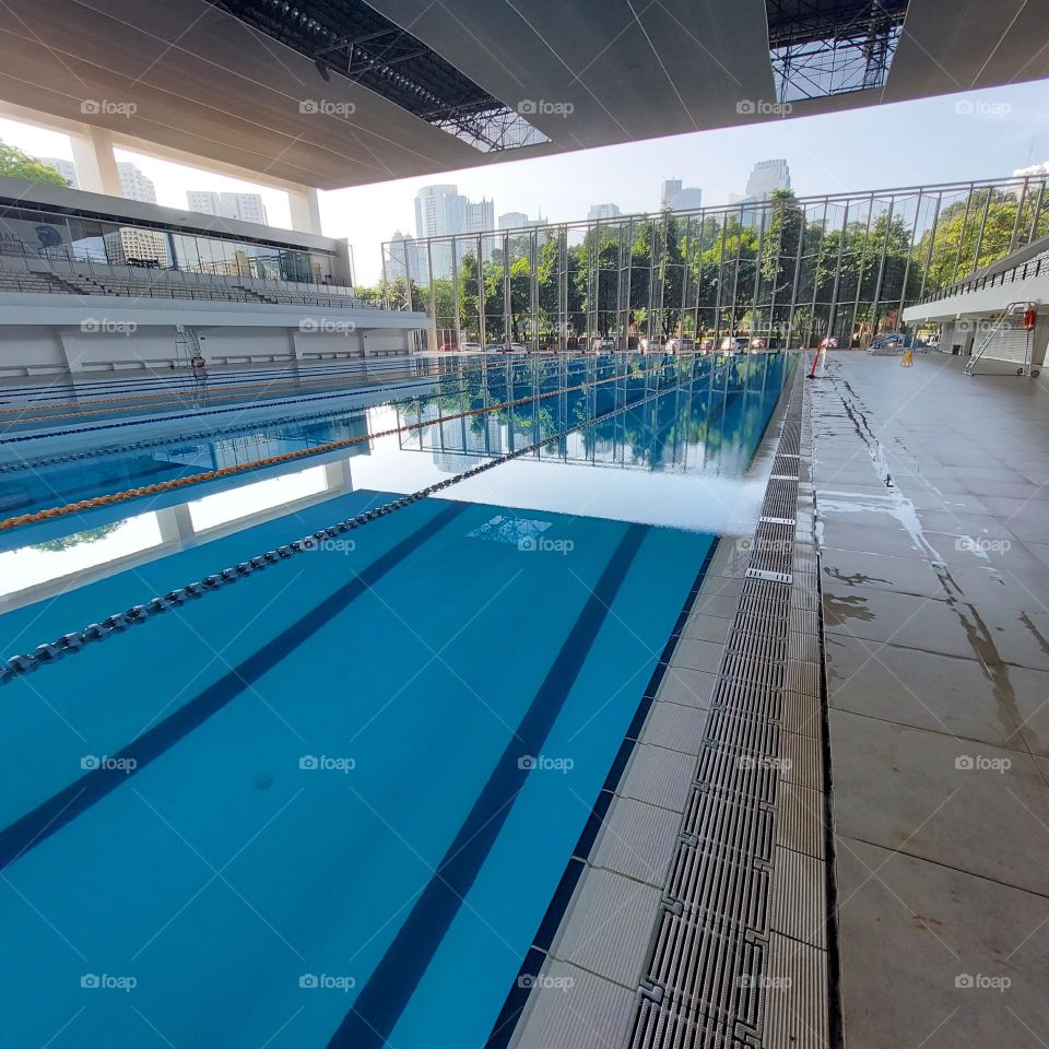 the pool area has been prepared for the swimming competition.  The swimming track has been installed in the pool and the championship is ready to start