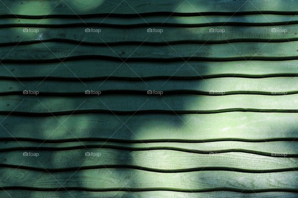 Full frame shot of a green wavy wooden roof