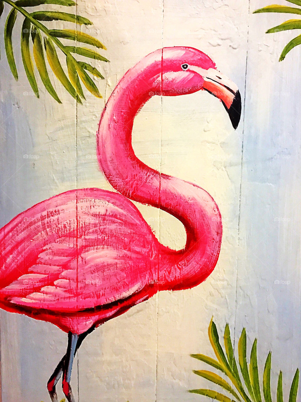 Pink flamingo painted  on a wooden wall.