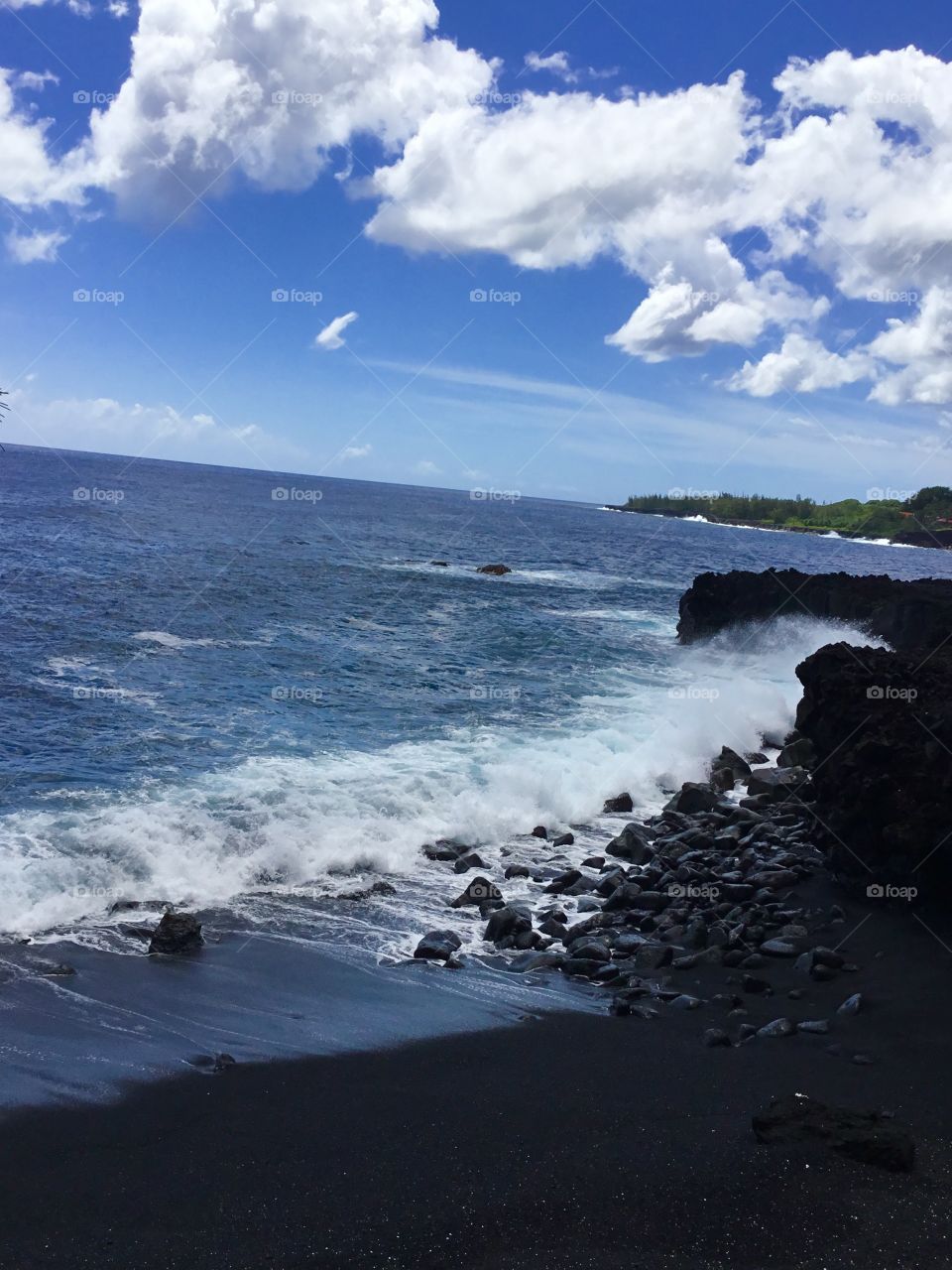 Black beach and white clouds