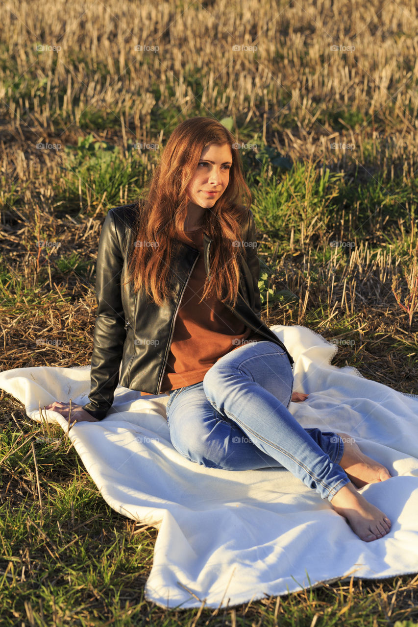 Woman sitting on grassy field