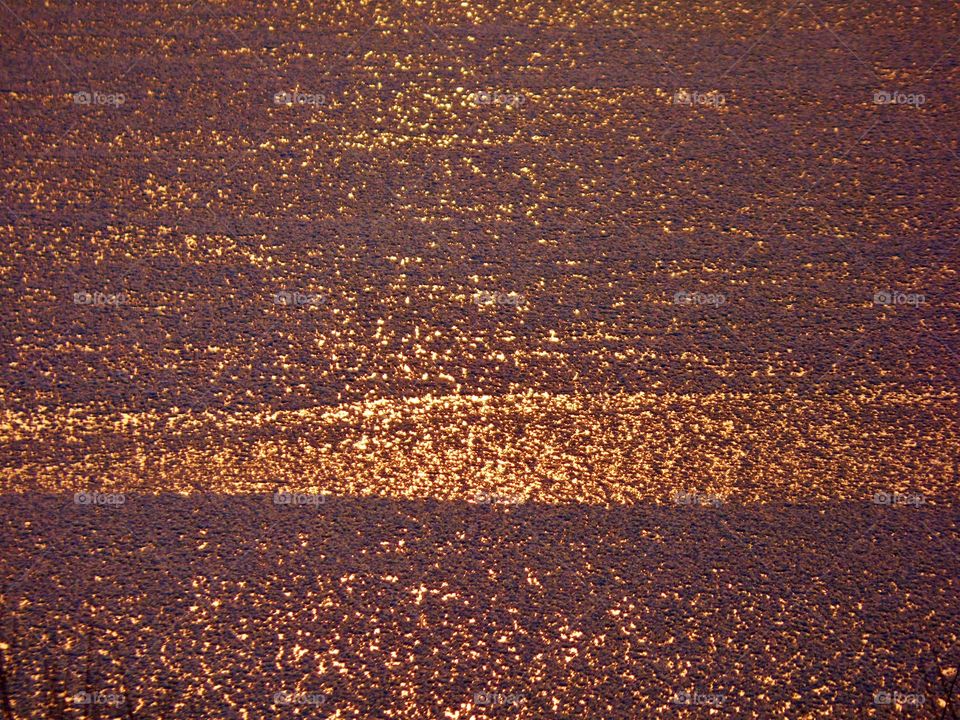 Sunset on the frozen lake. 