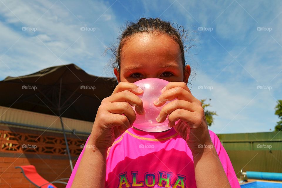 Girl with pink water balloon. Girl in pink with pink water balloon 