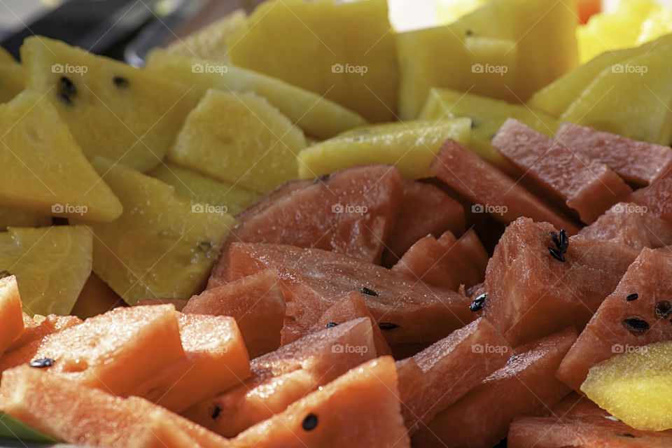 Watermelon red and yellow cut a small piece for eating.