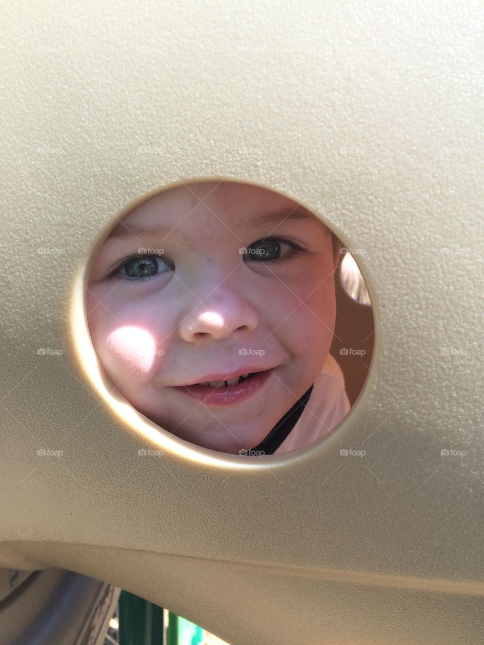 Peek a boo, I see you! Playing at the park with your toddler.