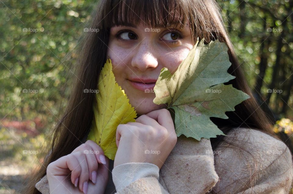 Smiling Young Girl on Autumn Background